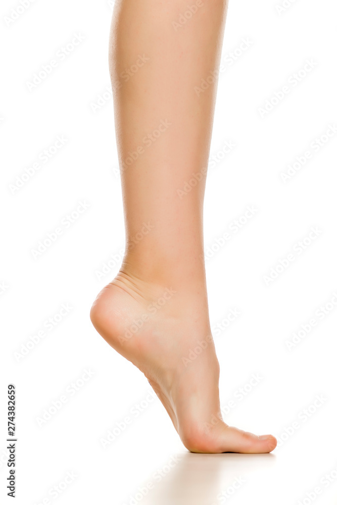 Side view of female bare foot on white background Side view of female bare foot on white background