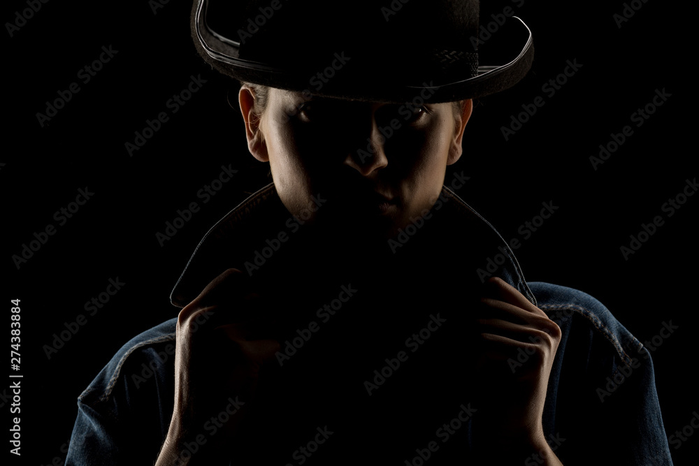 Silhouette of young unknown woman with kowboy hat on black background Silhouette of young unknown woman with kowboy hat on black background