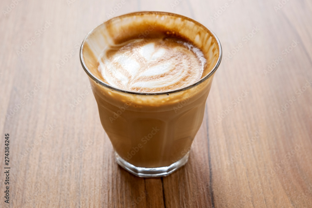 Hot latte on a wooden table Hot latte on a wooden table
