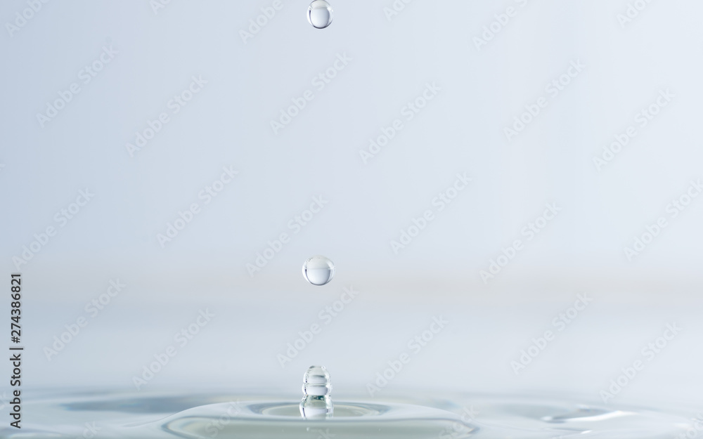 Splash from a drop of water on a light background macro