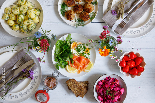 Fototapeta Scandinavian midsummer feast with potato salad, meatballs, salmon and beetroot