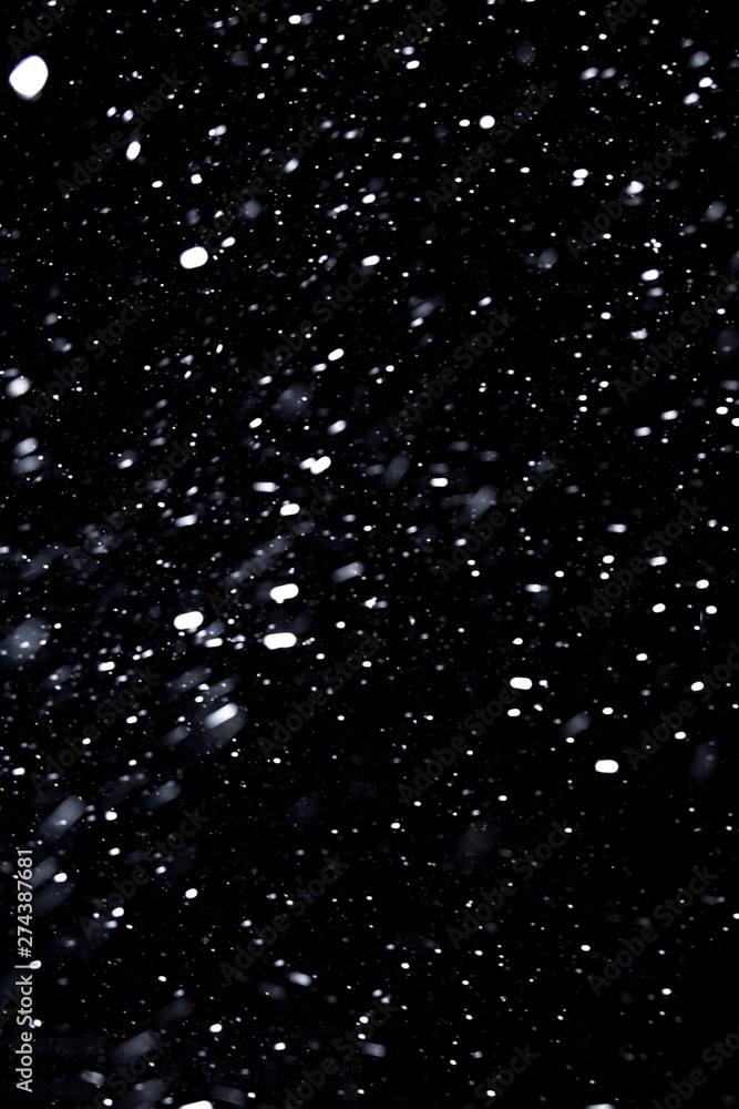falling snow on a black background, snowfall at night, white chaotic