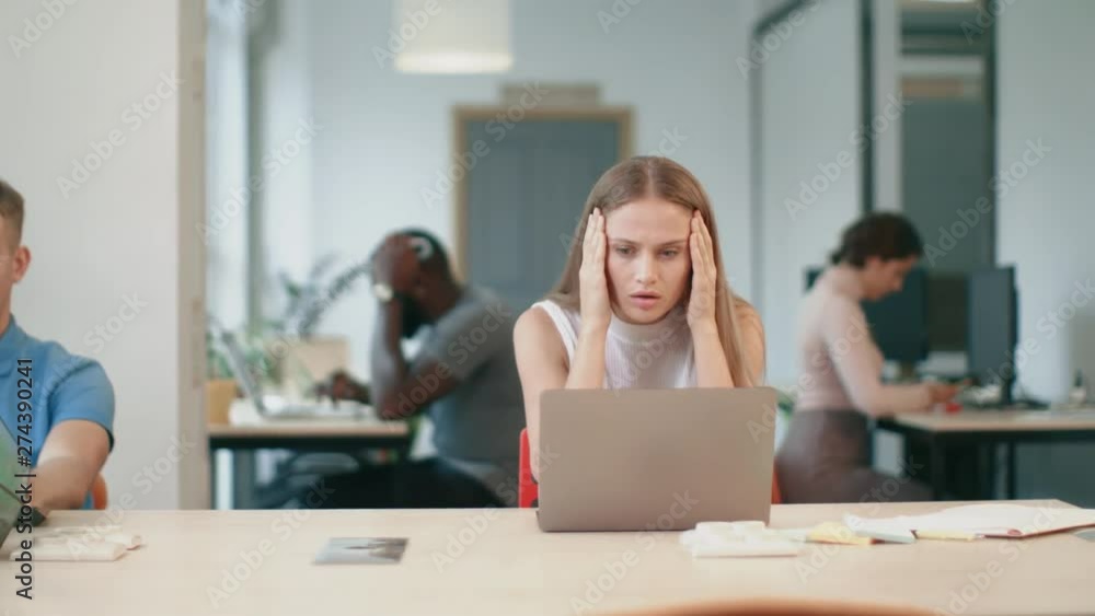 Business woman getting bad news on laptop in office. Freelance woman working Business woman getting bad news on laptop in office. Freelance woman working
