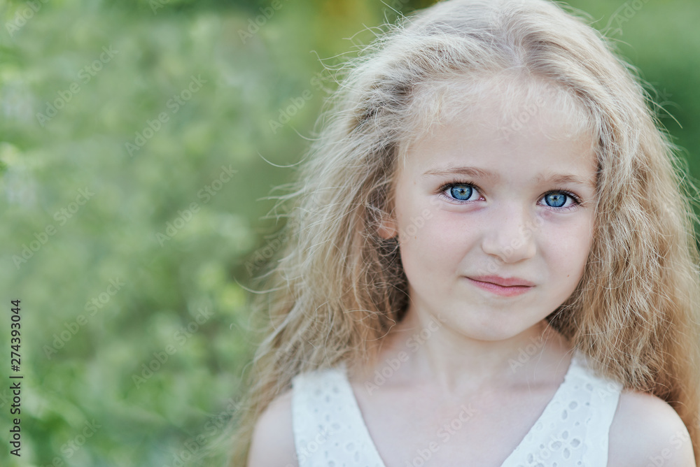 Close up portrait of beautiful little girl with blonde long hair and big blue eyes Close up portrait of beautiful little girl with blonde long hair and big blue eyes