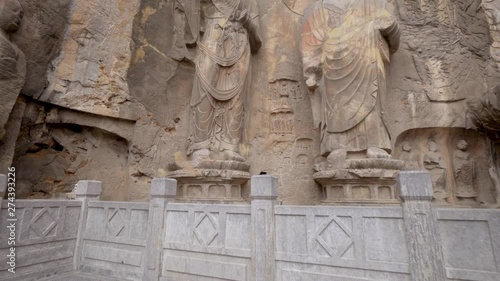 Wallpaper Mural The Longmen Grottoes are stone caves with broken Buddha statues of monks and protectors . Luoyang, Henan province, China. Torontodigital.ca