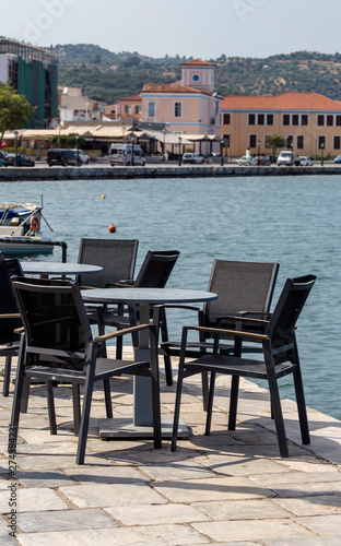 Tables and chairs of a street cafe (Greece, Peloponnese) © TETYANA