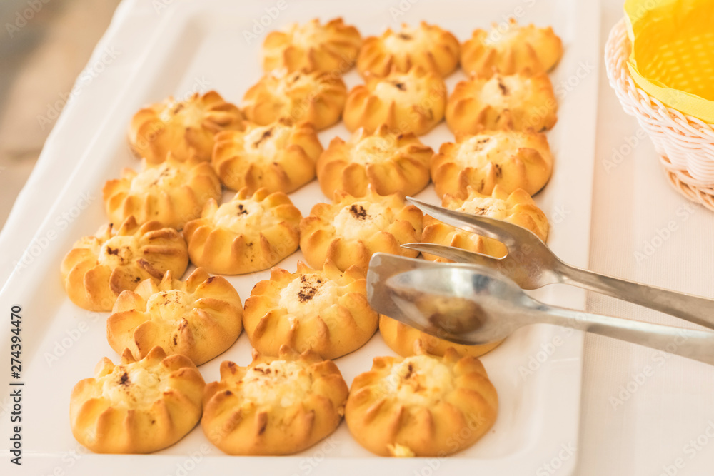 Cretan Sweet Cheese Pastries (Kalitsounia) on the table of the hotel restaurant, as a gift for guests in honor of the Easter holiday Cretan Sweet Cheese Pastries (Kalitsounia) on the table of the hotel restaurant, as a gift for guests in honor of the Easter holiday