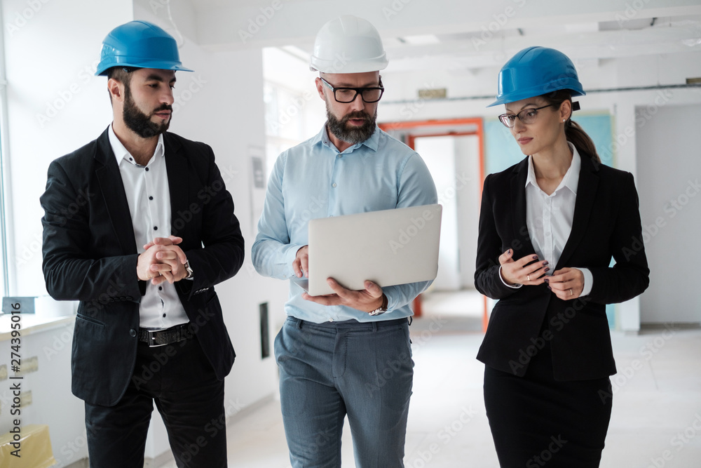 Engineers in hardhats have conversation Engineers in hardhats have conversation