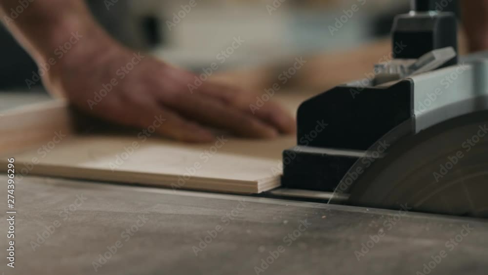 Saws furniture details with a circular saw. close up view of man wooden production factory furniture equipment Saws furniture details with a circular saw. close up view of man wooden production factory furniture equipment