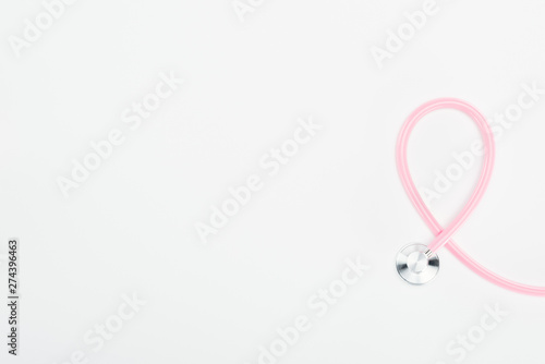 top view of stethoscope on white background with copy space, breast cancer concept