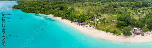 Port Orly sandy beach with palm trees, Espiritu Santo Island, Vanuatu.
