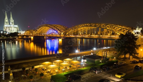 City Panorama at night, Cologne, Hohenzollern Bridge, Cathedral, Philharmonic Hall, Rhein, equestrian statue of Frederick William IV, glass roof and beer garden of the Hyatt Regency Hotel in front, Cologne, North Rhine-Westphalia, Germany, Europe