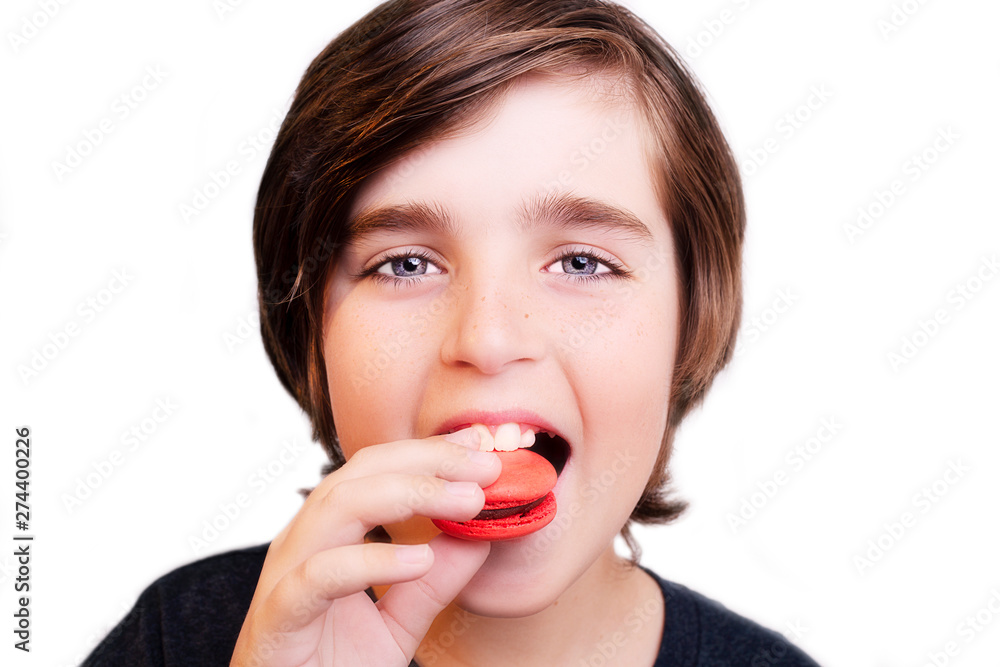 Handsome boy eating macaroni over white background. Handsome boy eating macaroni over white background.