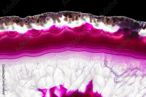 Purple violet agate slice striped mineral isolated on black, abstract background