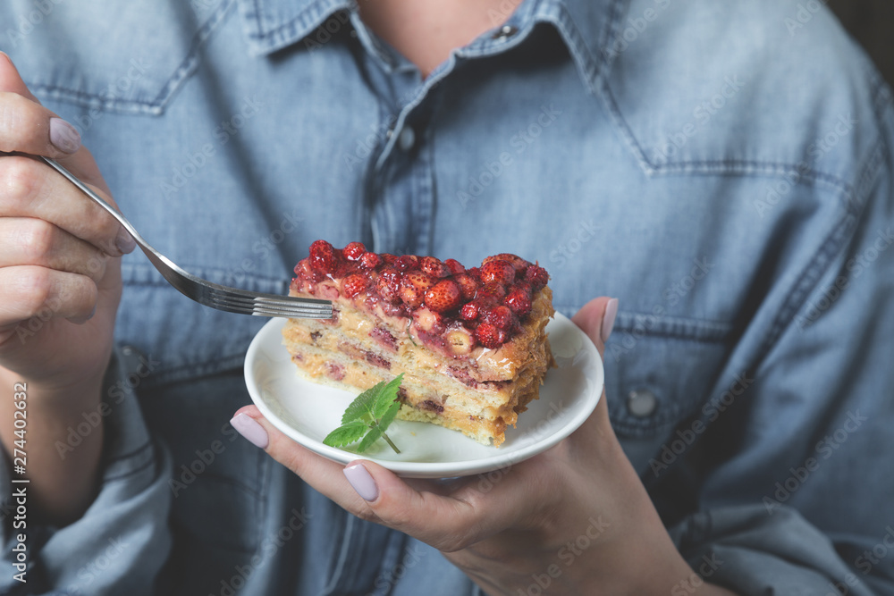 A piece of homemade cake with fresh strawberries