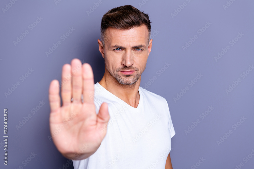 Close up photo amazing he him his middle age macho hand palm arm raised air angry look straight you will not pass through facial expression harsh wear casual white t-shirt isolated grey background - obrazy, fototapety, plakaty 