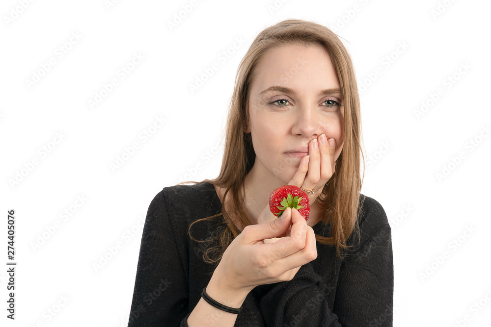 A Young woman is pain sensitive when eating sweet strawberry A Young woman is pain sensitive when eating sweet strawberry