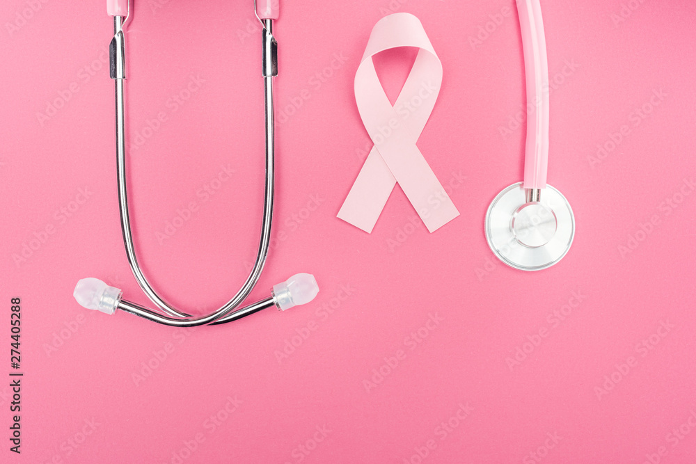 flat lay with stethoscope and pink breast cancer sign on pink background with copy space flat lay with stethoscope and pink breast cancer sign on pink background with copy space