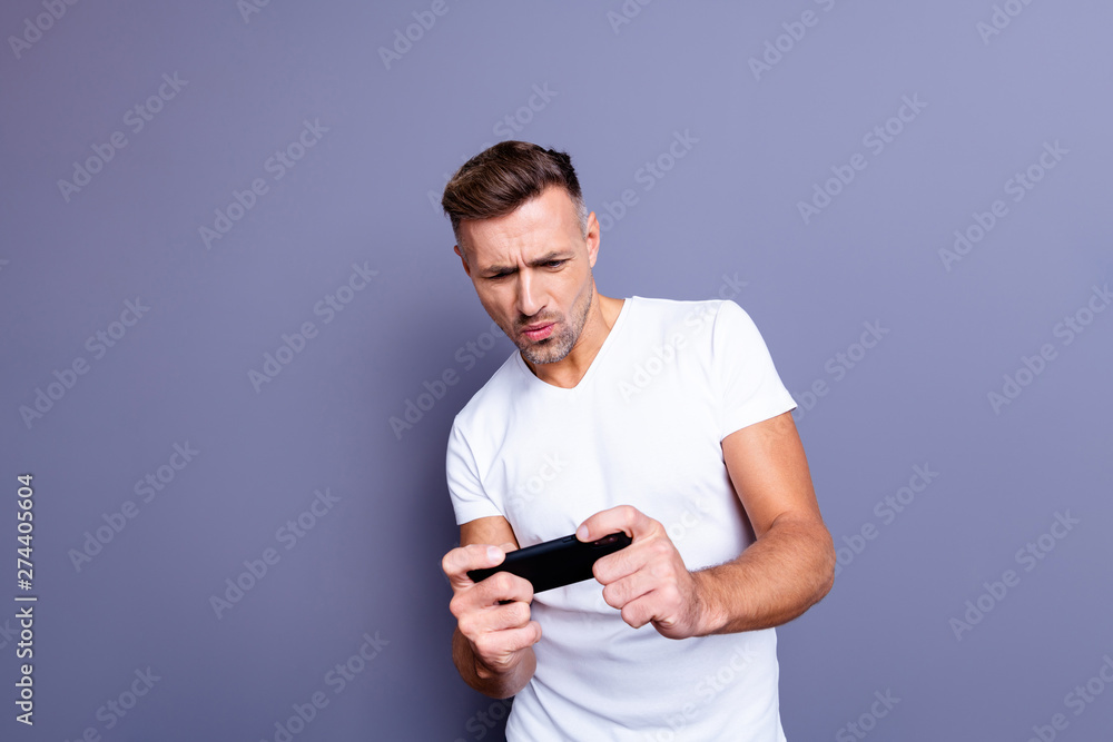 Close up photo amazing he him his middle age macho perfect appearance easy-going telephone hands arms excited video game player trying hard wear casual white t-shirt isolated grey background Close up photo amazing he him his middle age macho perfect appearance easy-going telephone hands arms excited video game player trying hard wear casual white t-shirt isolated grey background