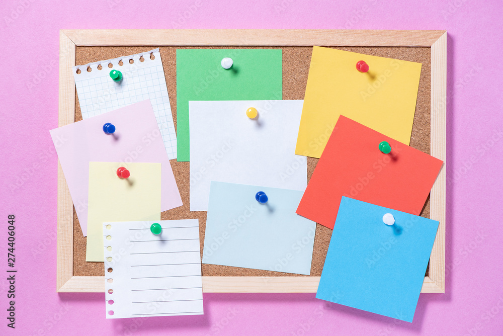 Corkboard for notes with empty sheets on buttons on a pink background Corkboard for notes with empty sheets on buttons on a pink background