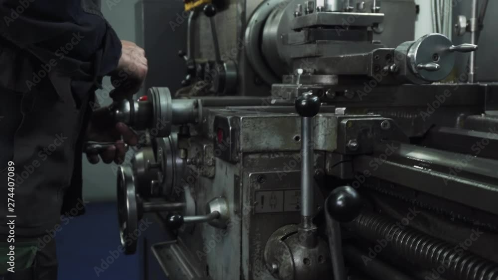 Metalworking Lathe Machine in Use. Lathe Operator in Action Metalworking Lathe Machine in Use. Lathe Operator in Action