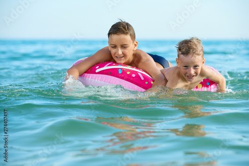 TWO BOYS SAVE ON A INFLATABLE CIRCLE AT SEA