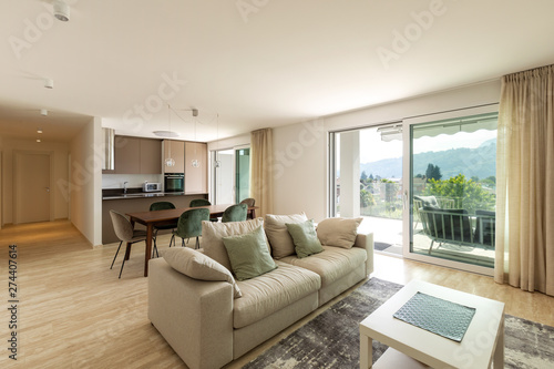 Modern living room with wood table  velvet chair and large sofa