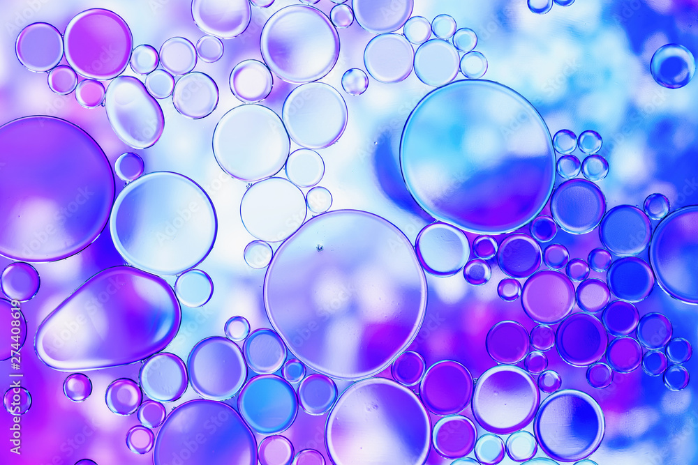 blue and purple oil bubbles in water with abstract pattern