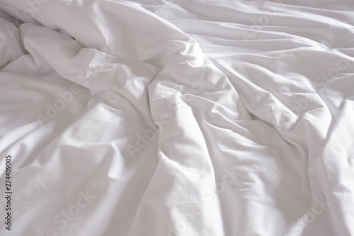 White crumpled bed sheet in a hotel room