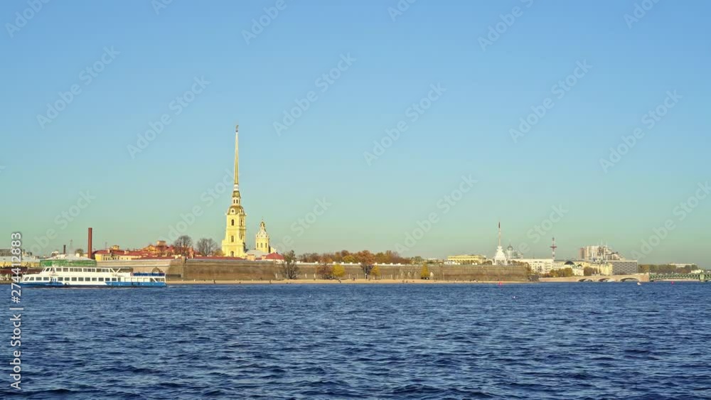 SAINT PETERSBURG, RUSSIA - MARCH 2019: View of Neva river and boat floating to the left on background of Peter and Paul Fortress in spring time at daylight. Clear blue sky with no clouds, bird flying SAINT PETERSBURG, RUSSIA - MARCH 2019: View of Neva river and boat floating to the left on background of Peter and Paul Fortress in spring time at daylight. Clear blue sky with no clouds, bird flying