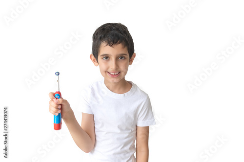Portrait of young boy holding toothbrush looking a camera. Teenager.
