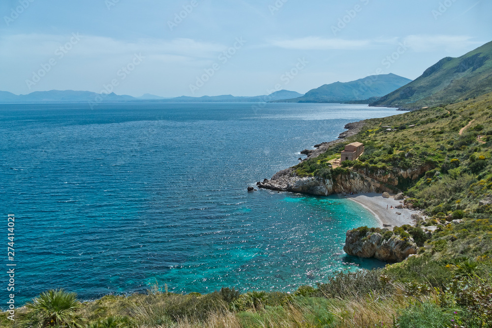 Obraz premium A panoramic view of Cala Tonnarella dell'Uzzo in the Oasi dello Zingaro natural reserve, San Vito Lo Capo, Sicily