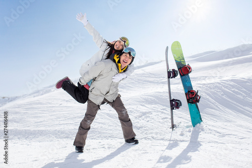 Happy young couple skiing in ski resort photo