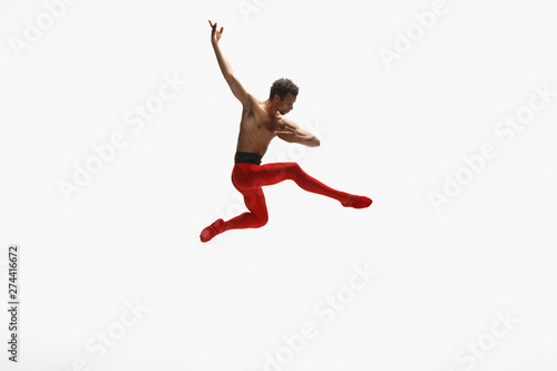 Graceful classic ballet dancer dancing isolated on white studio background. Man in bright red clothes like a combination of wine and milk. The dance  grace  artist  movement  action and motion concept