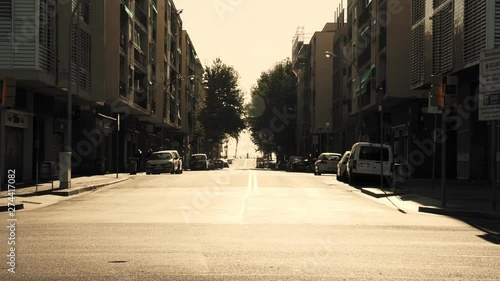 City in the morning. Warm soft light on the pavements, a few cars are on the road. Chill. 