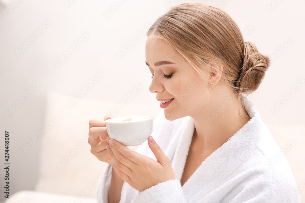 Beautiful young woman drinking coffee in spa salon Beautiful young woman drinking coffee in spa salon