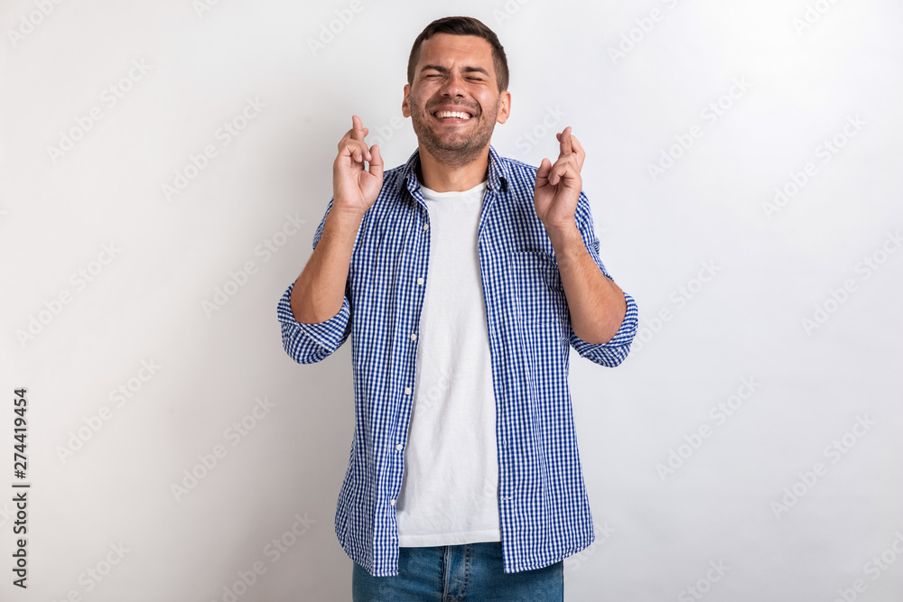 Fototapeta premium Man makes a gesture from crossing fingers in studio . - Concept dool luck gesture. - Image
