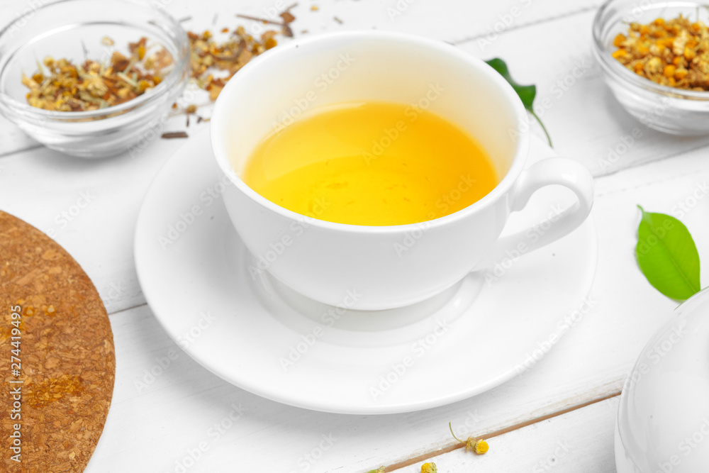 Cup of tea and tea leaves on white wooden table. close up. Cup of tea and tea leaves on white wooden table. close up.