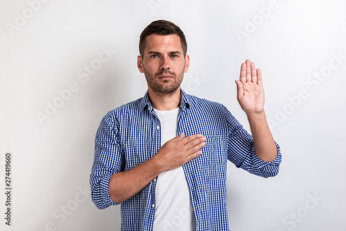 Fotografie Serious man makes a gesture swear. Concept gesture.- Image
