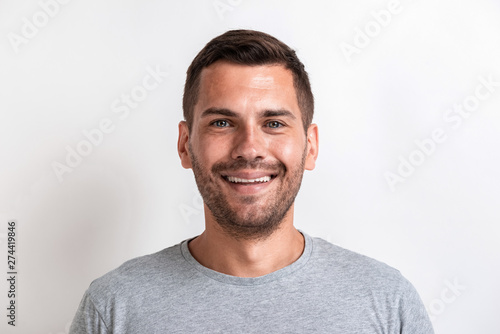 Closeup male studio portrait of happy man looking at the camera.- Image