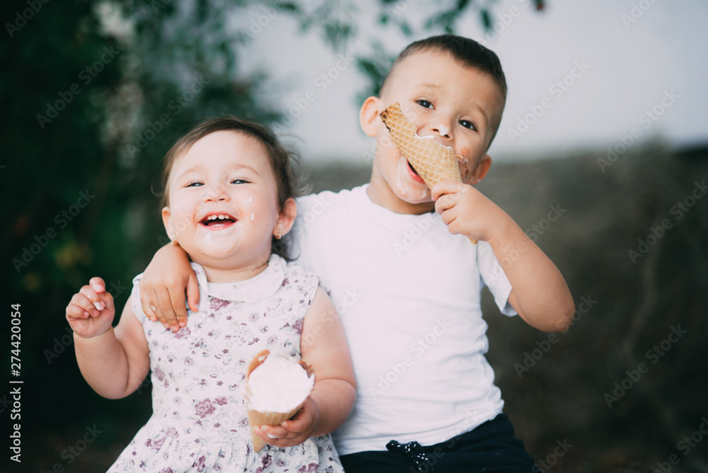 Kids eat ice cream in summer outside and cuddle, very cute Kids eat ice cream in summer outside and cuddle, very cute