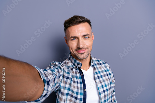 Self-portrait of his he nice-looking attractive well-groomed cheerful calm bearded grey-haired guy wearing checked shirt isolated over blue violet pastel background