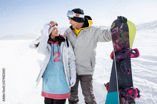 Happy young couple skiing in ski resort photo