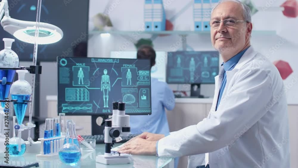 Portrait of adult researcher looking at the camera. He works in modern research facility Portrait of adult researcher looking at the camera. He works in modern research facility