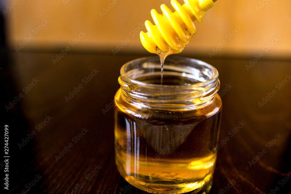honey in glass jar with dipper honey in glass jar with dipper