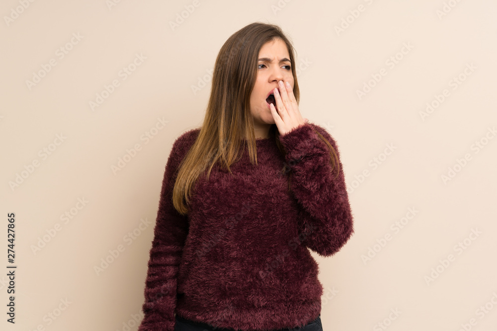 Young girl yawning and covering wide open mouth with hand Young girl yawning and covering wide open mouth with hand