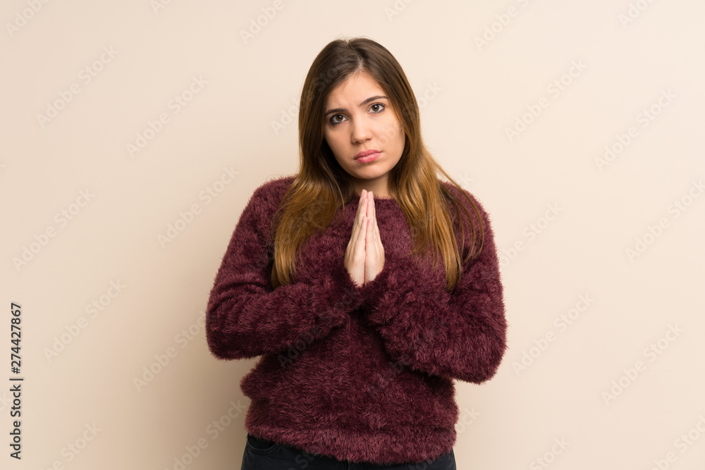 Young girl keeps palm together. Person asks for something Young girl keeps palm together. Person asks for something