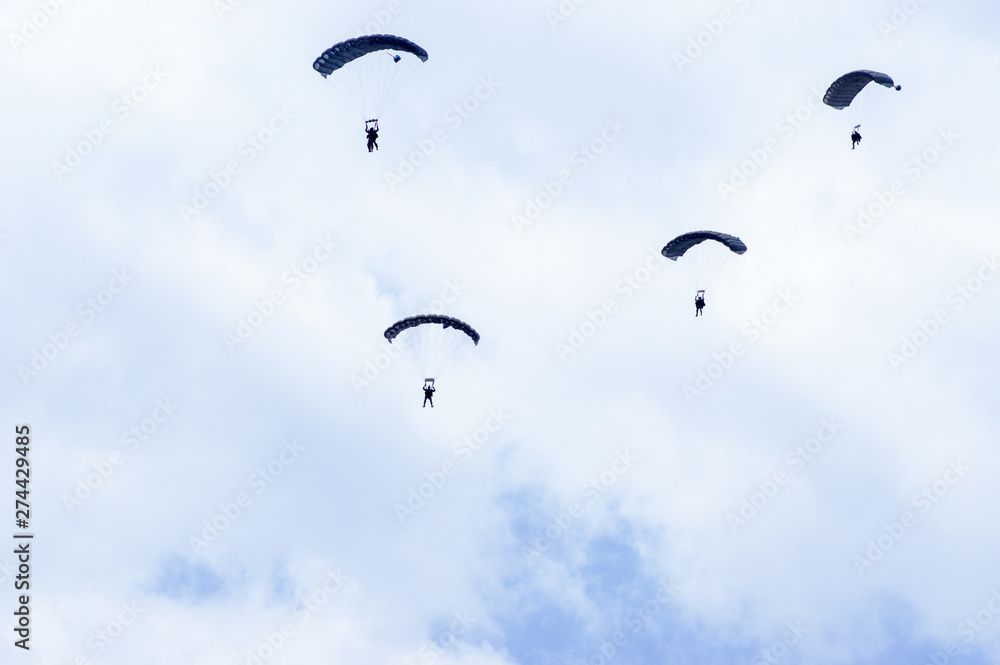 Military parachutists also called paratroopers in the sky with many clouds. Military parachutists also called paratroopers in the sky with many clouds.
