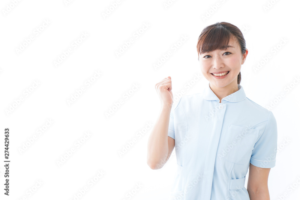 ガッツポーズをする若い看護師 ガッツポーズをする若い看護師