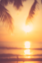 Blur beautiful nature green palm leaf on tropical beach with bokeh sun light wave abstract background.